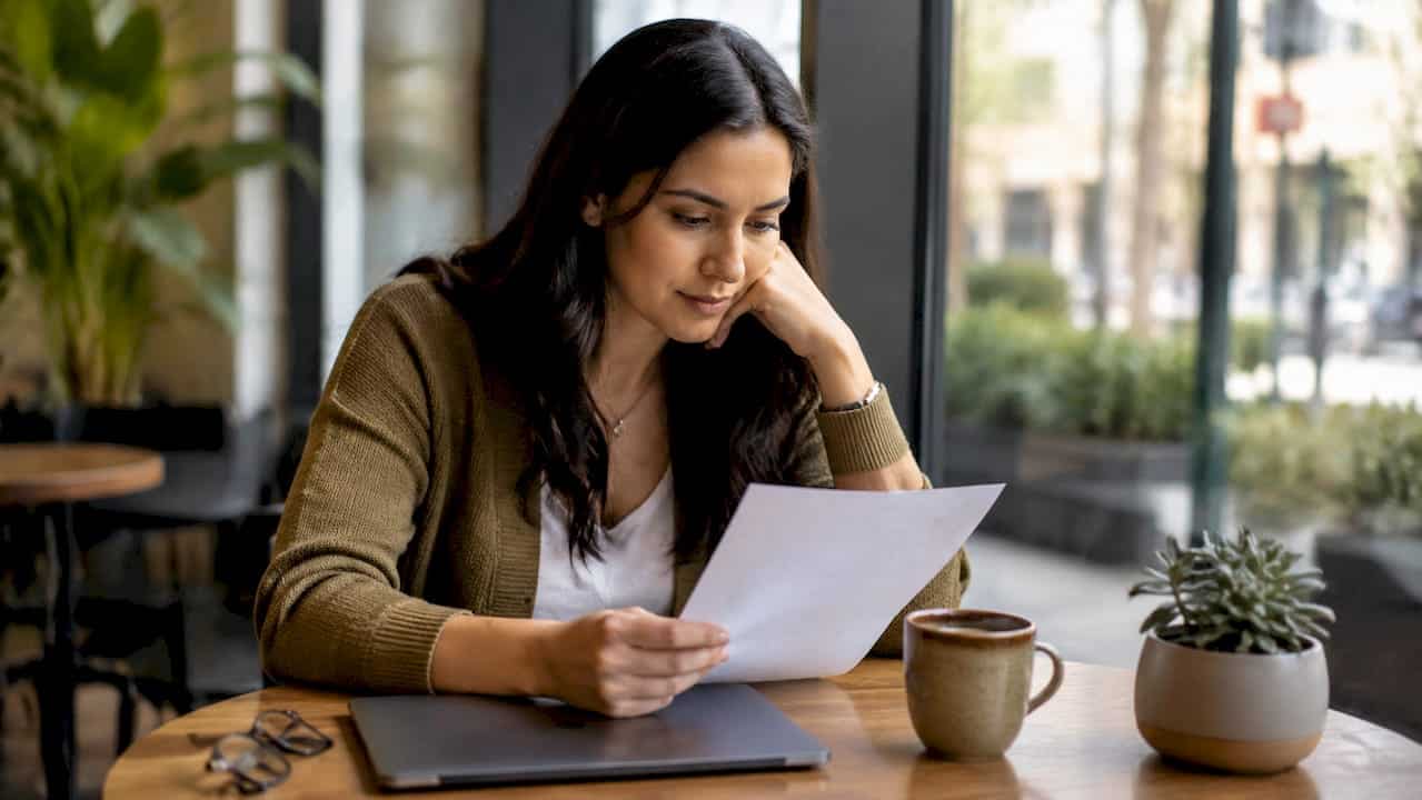 Woman reviewing FSA eligible treatments list at table