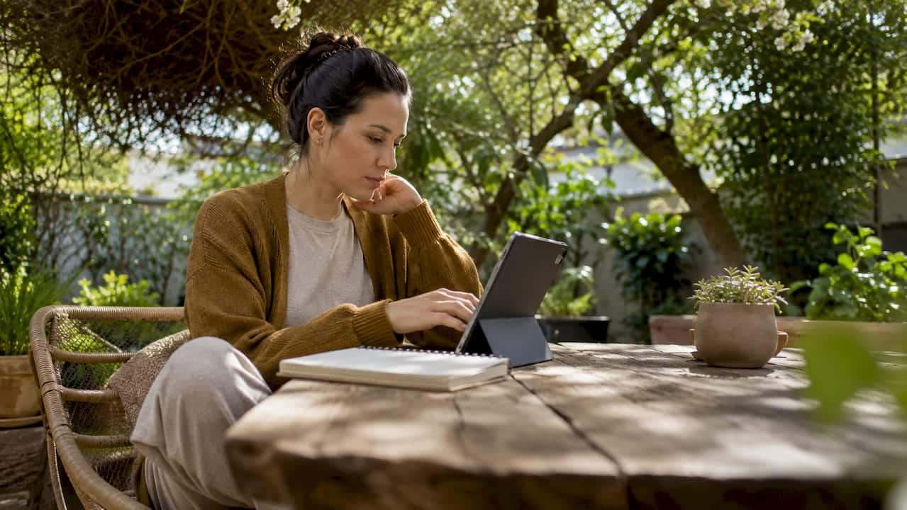Woman completing telehealth intake form on tablet