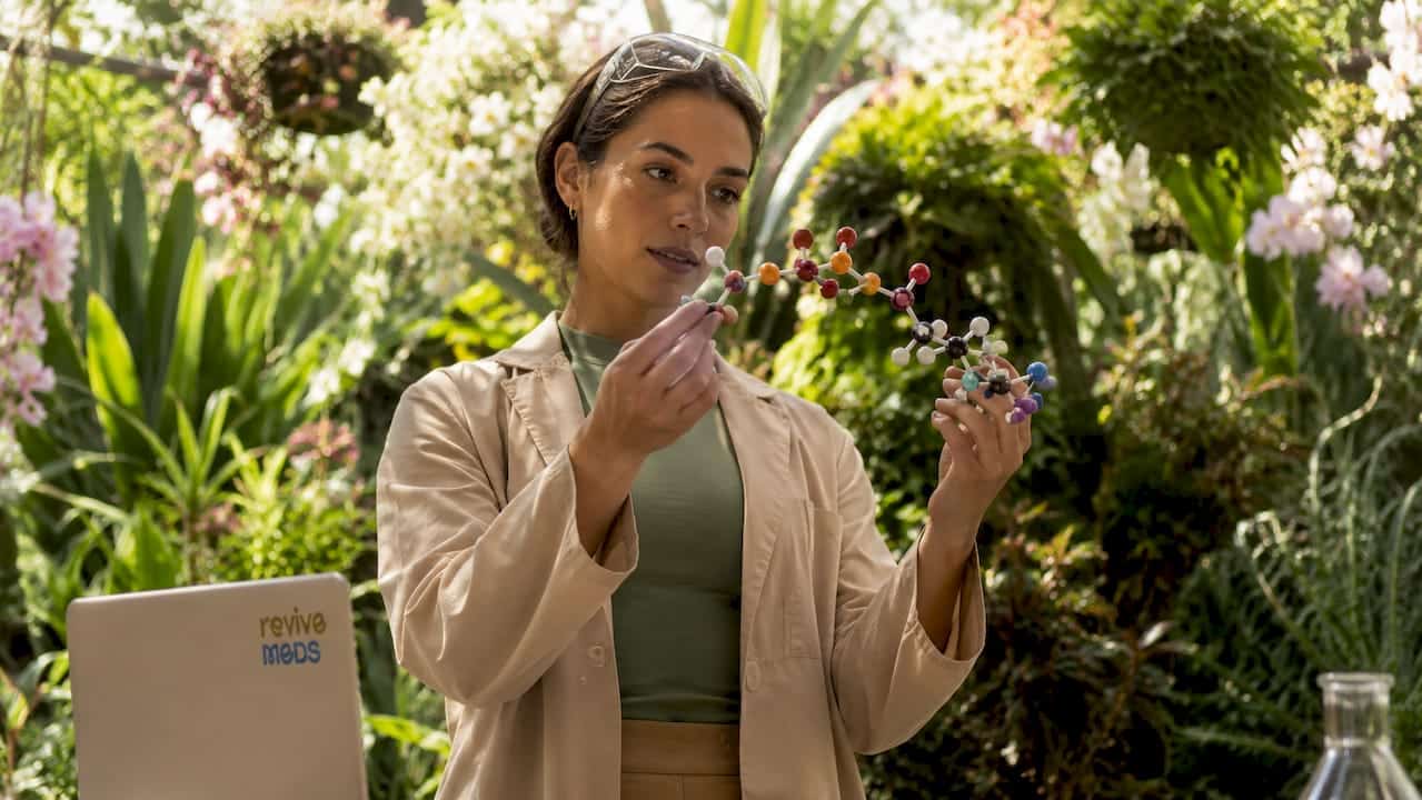 Scientist holding peptide molecular model in lab
