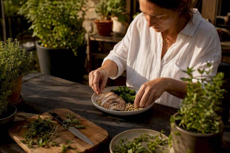 Woman plating protein-rich meal in kitchen